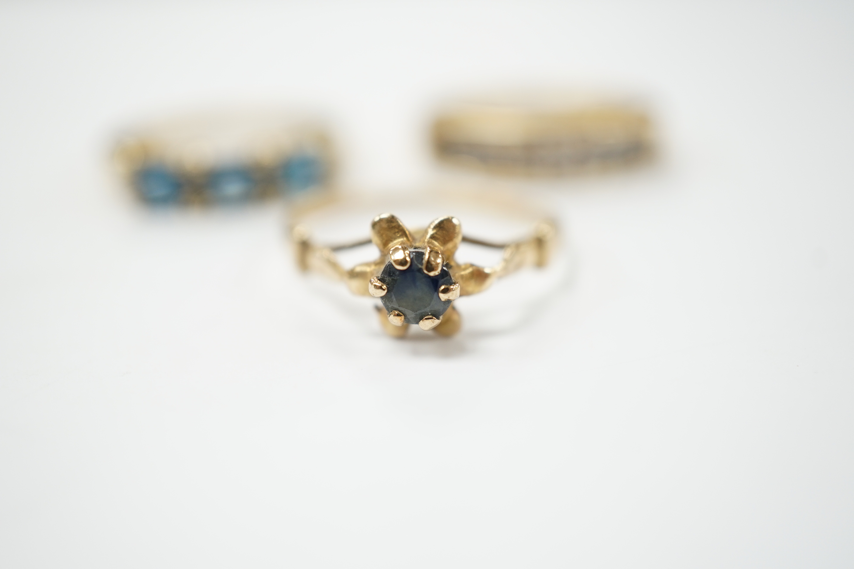 Two 9ct gold dress rings, one set with sapphire and diamonds, the other a single sapphire, and a diamond chip set ring, stamped 925, size M